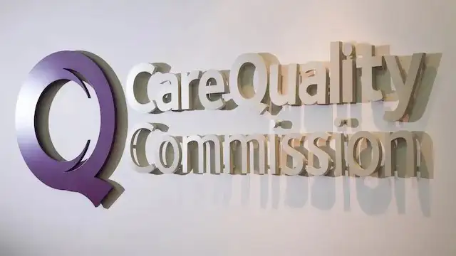 A picture of the CQC logo. The logo has a massive letter 'q' in the colour purple and 'care quality commission' next to it