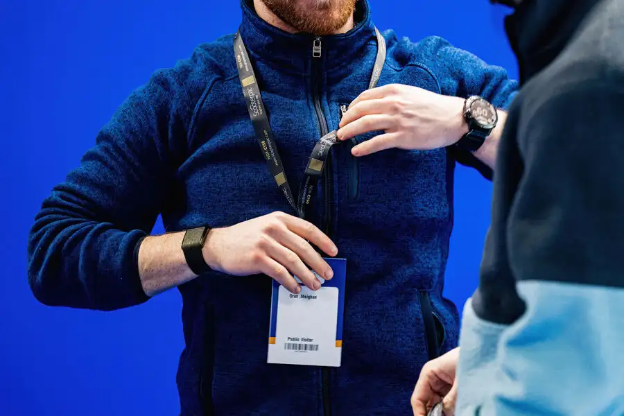 Man showing pass to onlooker