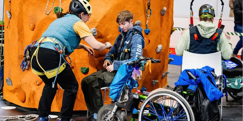 Accessible climbing wall with adaptive equipment