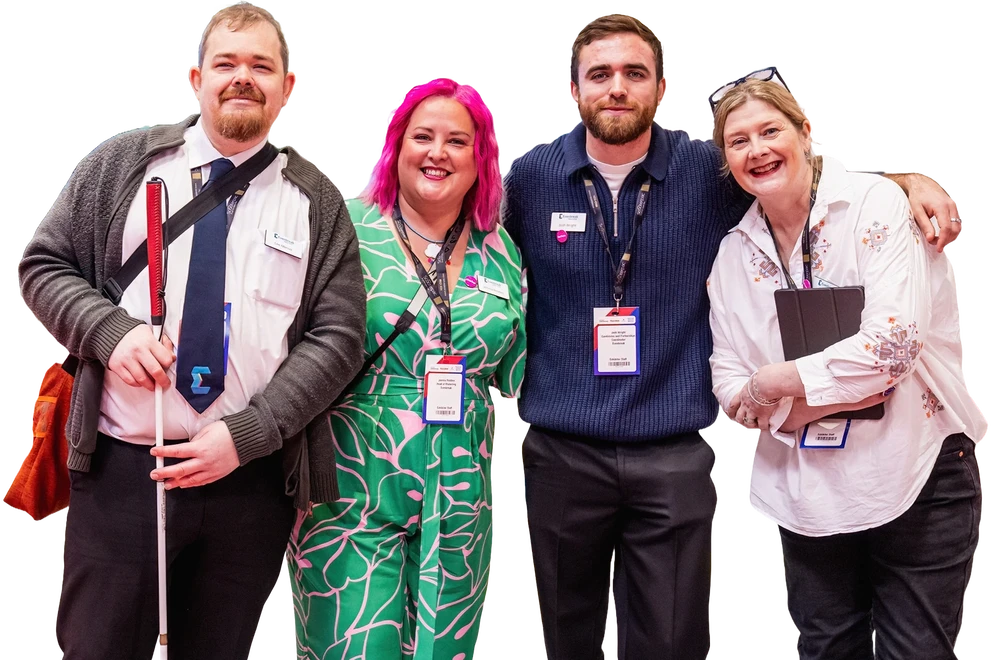 Four people attending Naidex together smiling