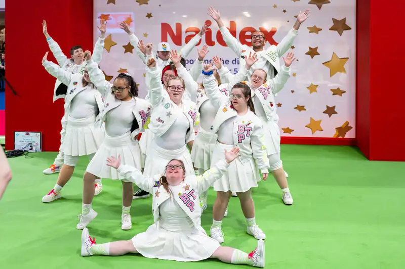 Children performing an energetic dance routine on the Naidex Junior stage.