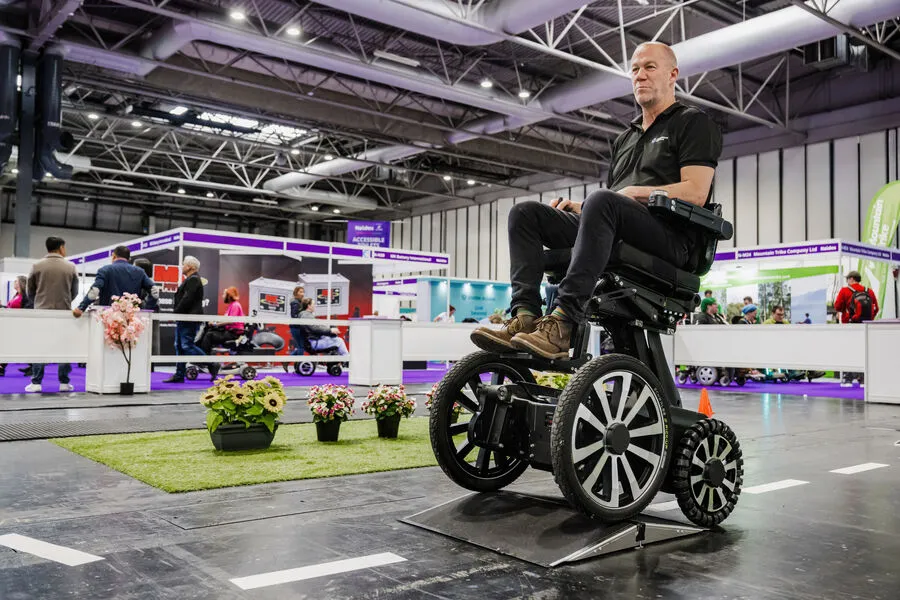 People walking and browsing through Naidex exhibition hall