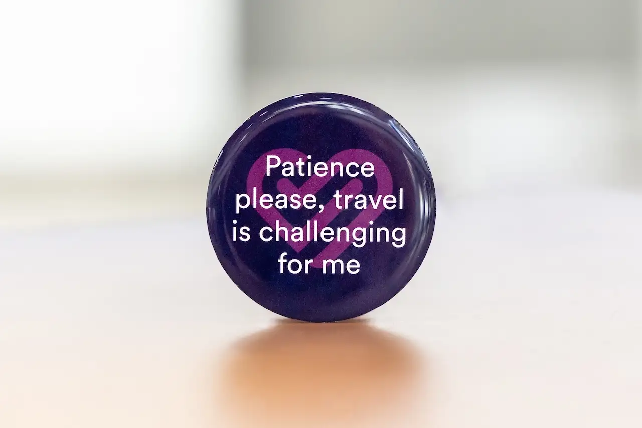 Photo of Trainline badge for people with Parkinson's saying 'patience please, travel is challenging for me'