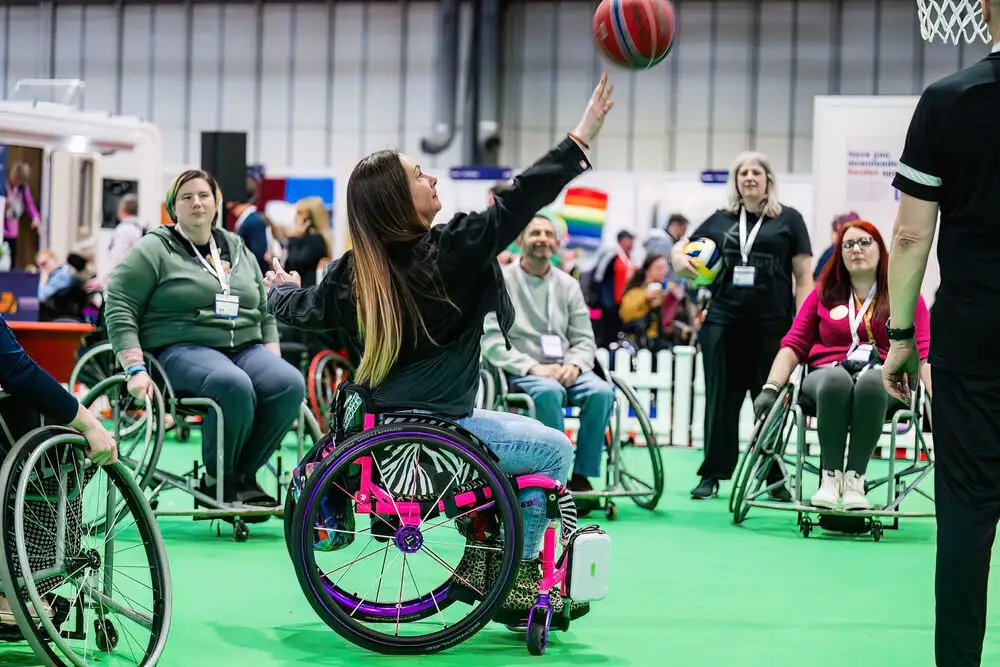 Woman in wheelchair throwing a basketball