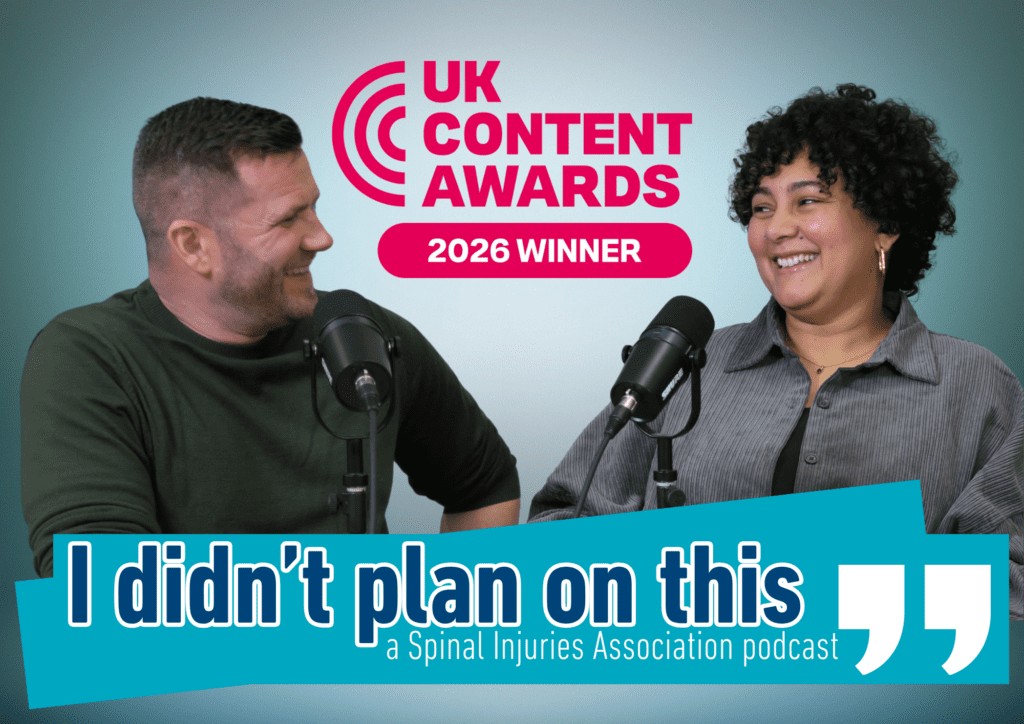 Two podcast hosts sit facing each other in a professional recording studio, smiling warmly during a conversation. Both are speaking into microphones mounted on desk stands. Above them is the UK Content Awards 2026 Winner logo. A bold turquoise banner across the bottom of the image displays the podcast title, "I didn't plan on this", with the subtitle "a Spinal Injuries Association podcast" and oversized quotation marks on the right. The background is a soft blue gradient, creating a clean and inviting promotional image.