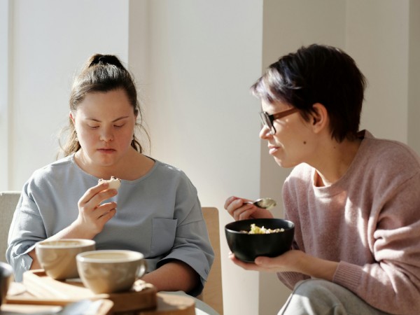 Two people sat at a table eating food