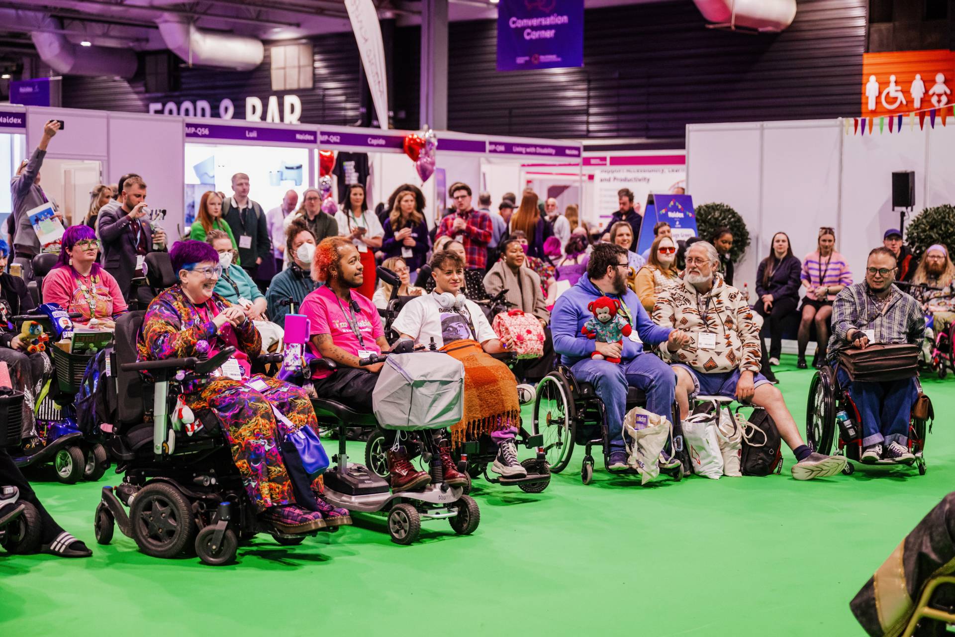 Crowd seat at Naidex engaged and smiling